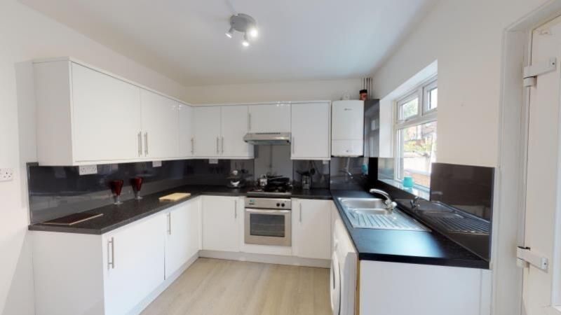 Property photo 2 of 6 Bright And Modern Kitchen Featuring White Cabinetr...