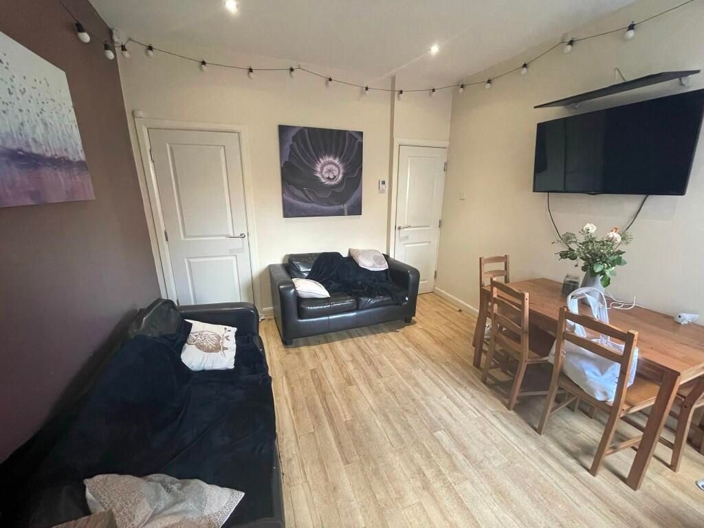 Property photo 2 of 9 A Cozy Living Room Featuring Comfortable Black Sof...