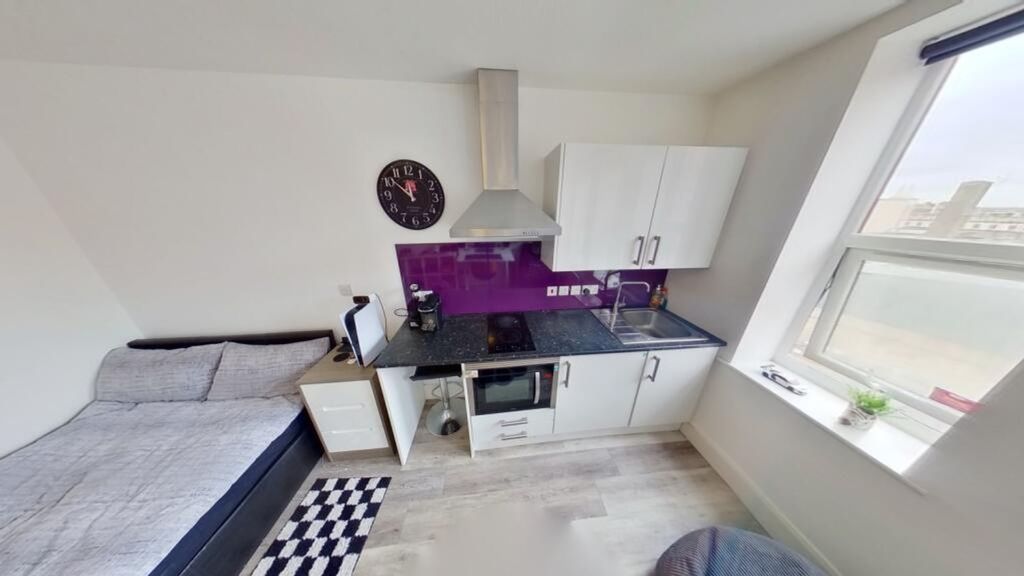 Property photo 3 of 4 This Charming Kitchen Area Features Modern Applian...