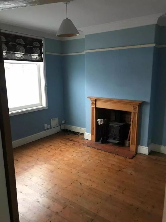 Property photo 2 of 8 A Charming Living Room Featuring Natural Wood Floo...
