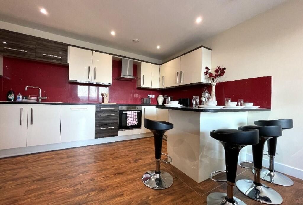 Property photo 1 of 13 A Modern, Spacious Kitchen Featuring Sleek White c...