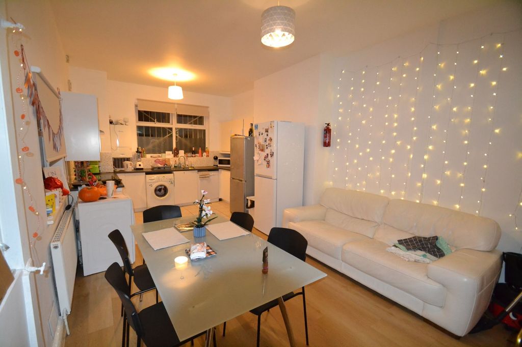 Property photo 1 of 26 A Cozy And Well-Lit Living Room Featuring Warm Lig...