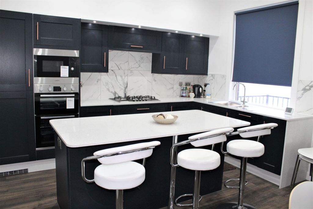 Property photo 1 of 6 Modern Kitchen Featuring Sleek Dark Cabinetry With...