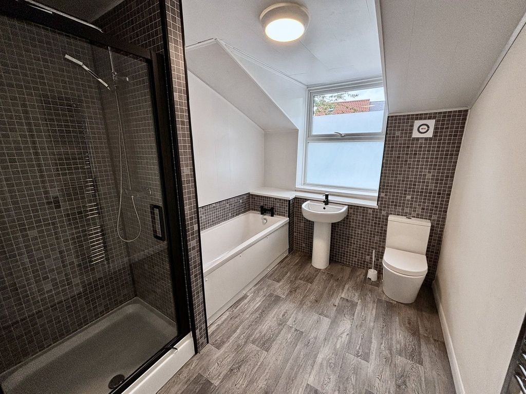 Property photo 3 of 13 A Spacious And Modern Bathroom Featuring Both A Sh...