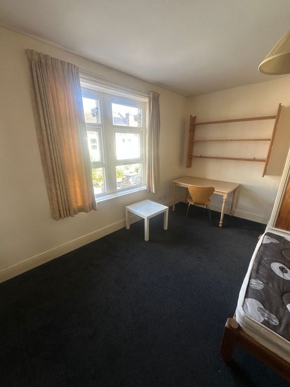 Property photo 3 of 8 Bright Bedroom With Desk And Ample Shelving...