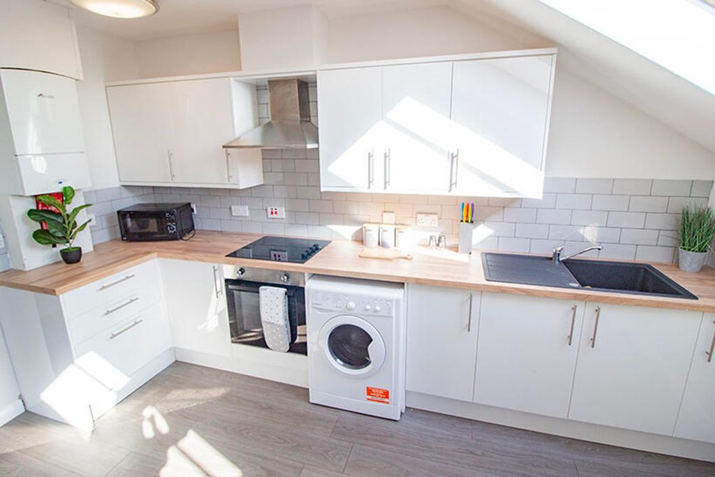 Property photo 3 of 7 A Modern Kitchen Featuring Sleek Cabinetry, Ample ...