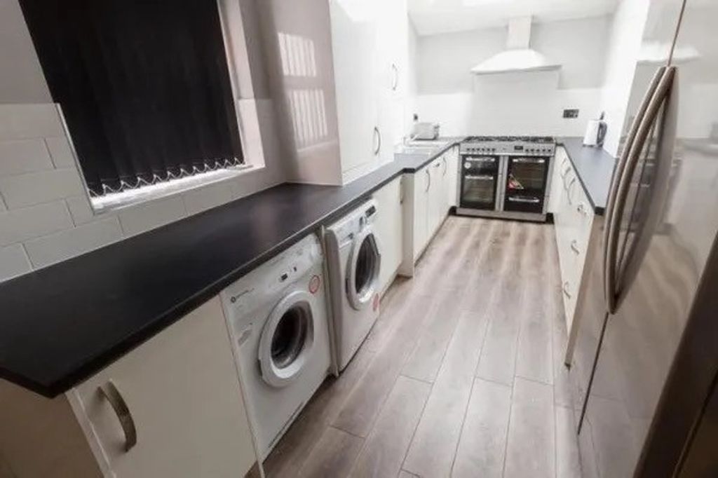 Property photo 3 of 5 A Spacious And Modern Kitchen Featuring Ample Coun...