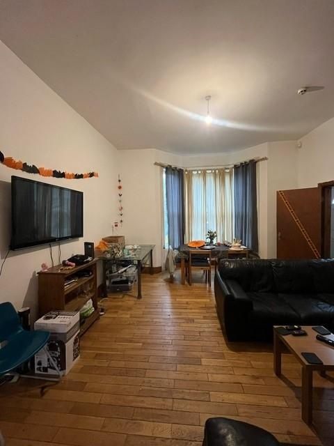 Property photo 2 of 28 A Spacious, Well-Lit Living Room Featuring A Large...