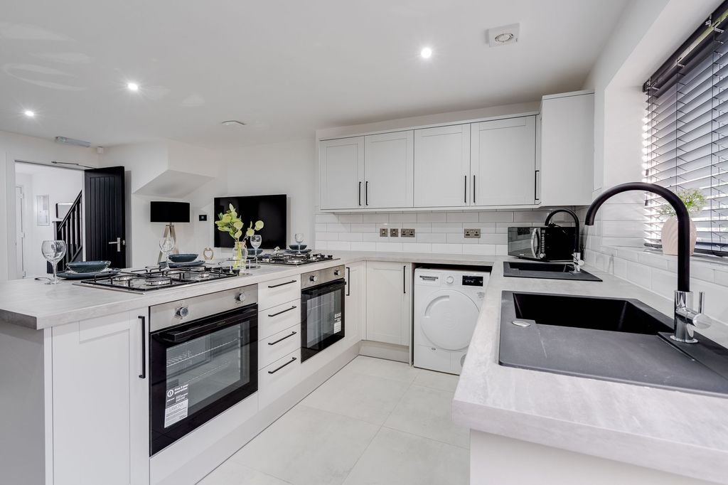 Property photo 2 of 4 Modern And Bright Kitchen Featuring White Cabinetr...