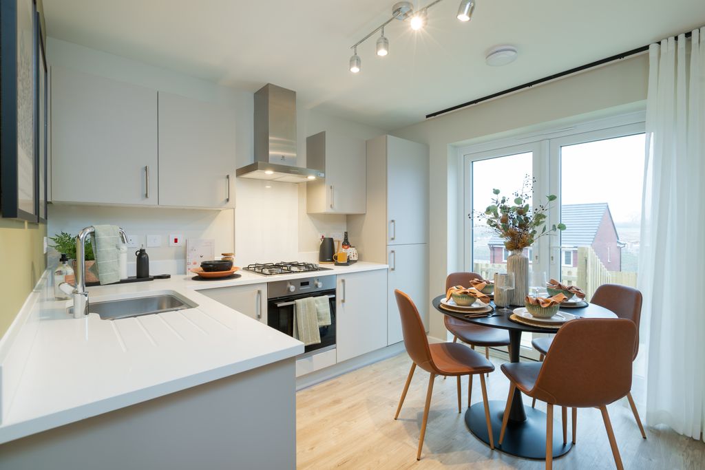 Property photo 2 of 8 A Modern Kitchen With A White Countertop And Stainless Steel Appliances In The Foreground Is Complem