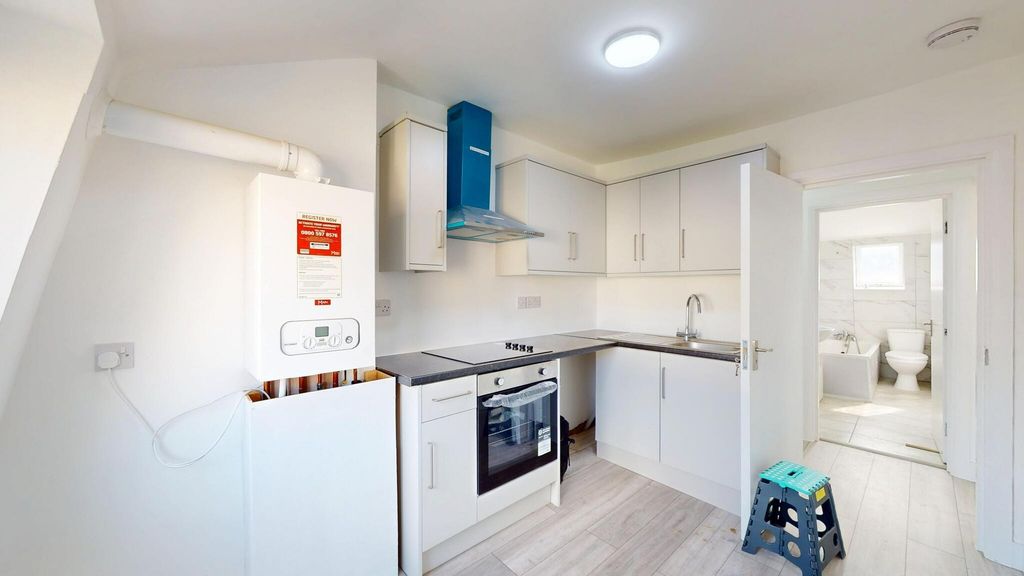 Property photo 3 of 8 Bright, Modern Kitchen With White Cabinetry, A Sle...