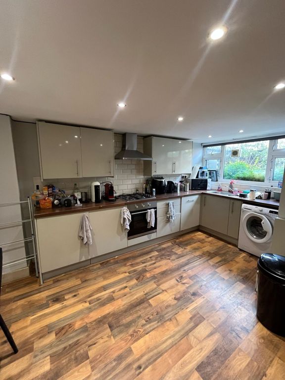 Property photo 3 of 14 Modern Galley-Style Kitchen With Glossy Fitted Cab...