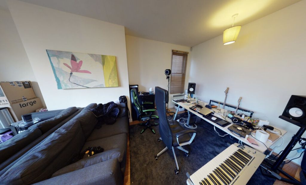 Property photo 3 of 7 A Contemporary Living Room Featuring A Large Sofa,...