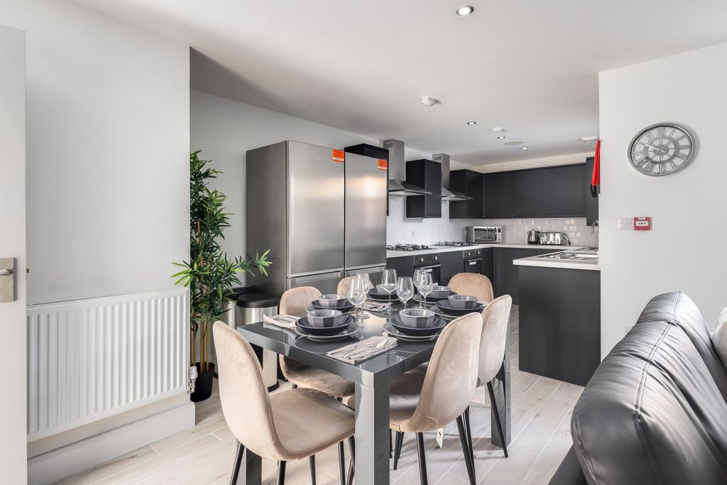 Property photo 3 of 11 Modern Kitchen With Sleek Black Cabinetry, Stainle...
