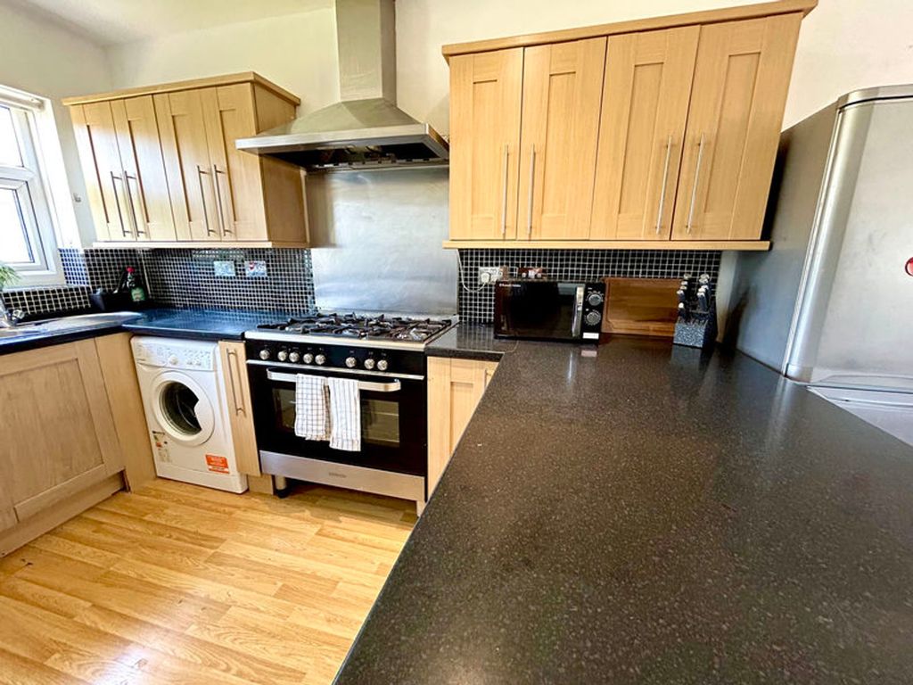 Property photo 3 of 6 A Spacious And Modern Kitchen Featuring Sleek Cabi...