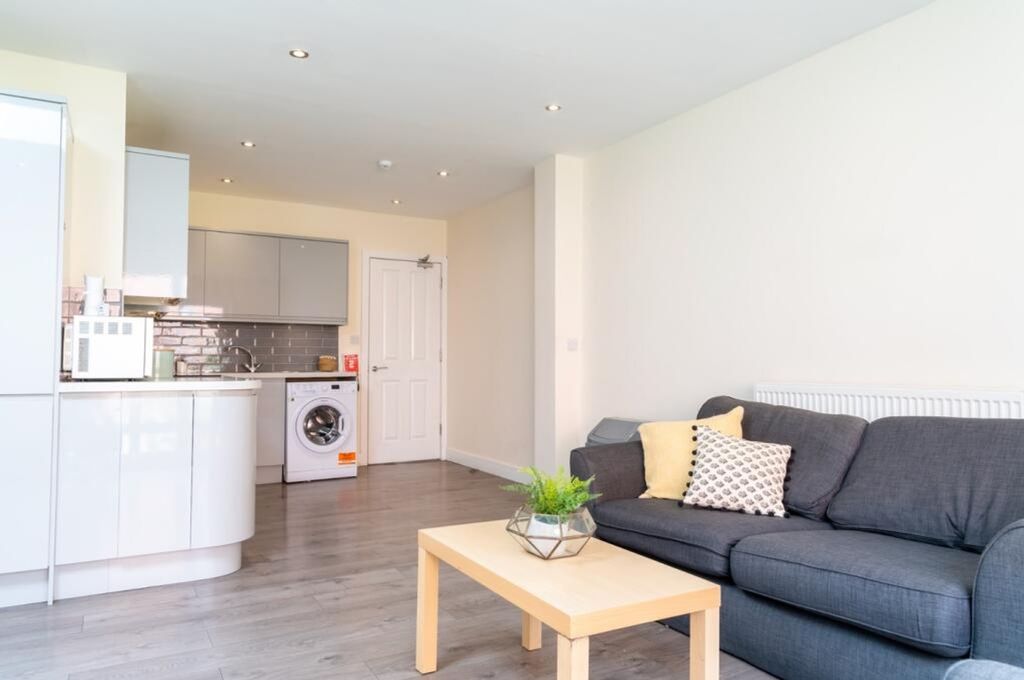 Property photo 3 of 15 This Stylish Living Room Features A Cozy Sofa And ...