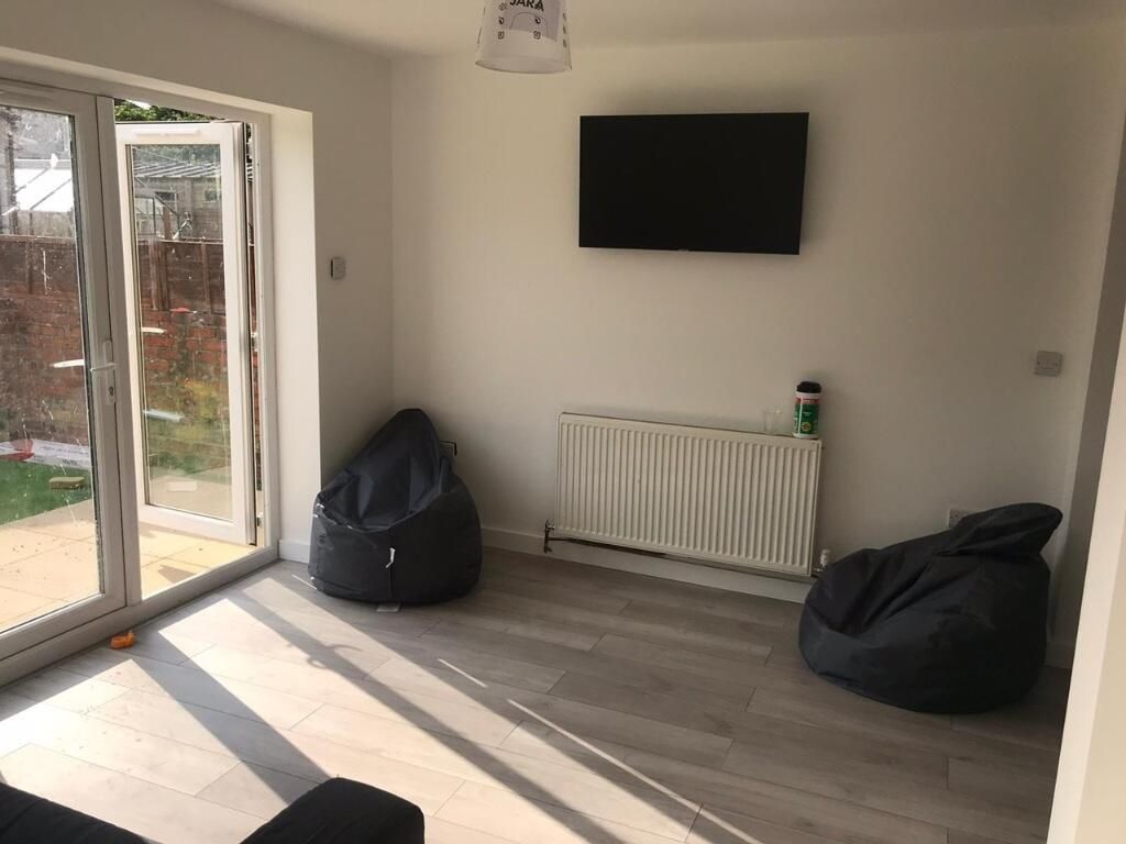 Property photo 1 of 15 A Bright And Modern Living Room Featuring Large Sl...