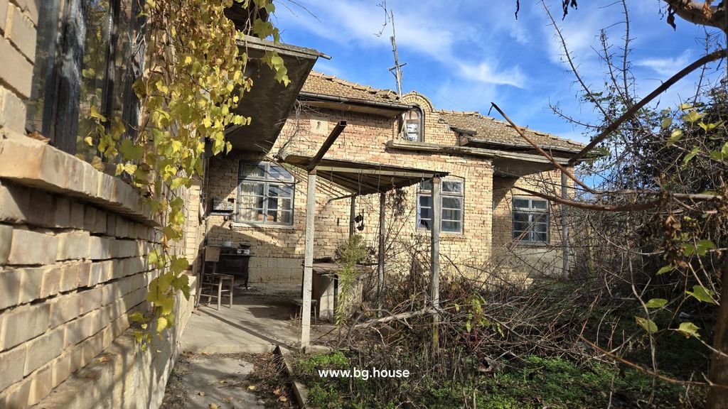 Property photo 1 of 53 View Of The Brick House Exterior Featuring A Tiled Roof And A Covered Porch With Outdoor Furniture And Dry Vegetation