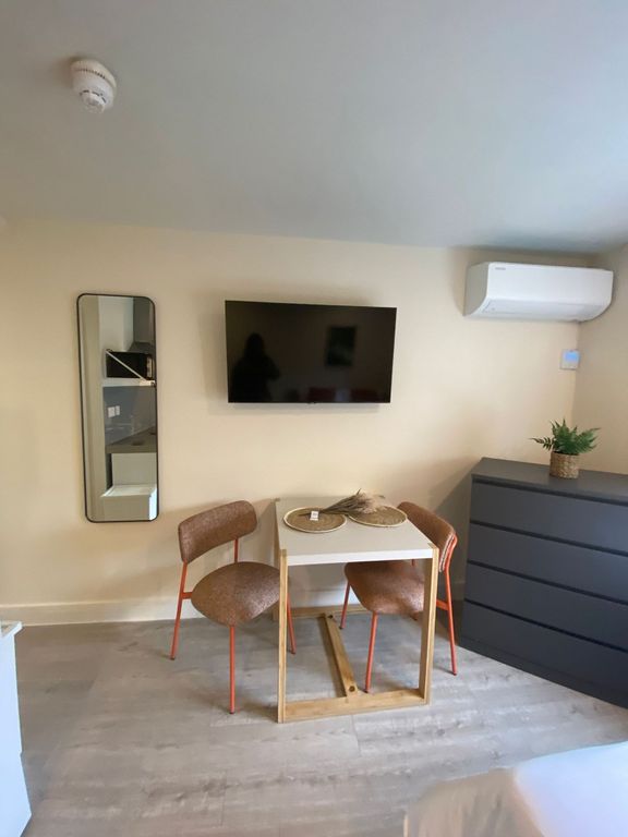 Property photo 2 of 8 Bright, Modern Bedroom Area With A Wall-Mounted TV...