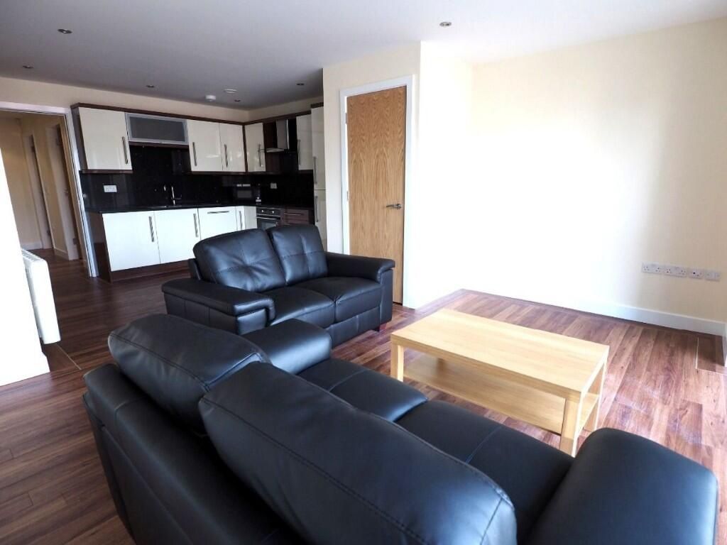 Property photo 3 of 10 A Contemporary Living Room Featuring Dark Leather ...