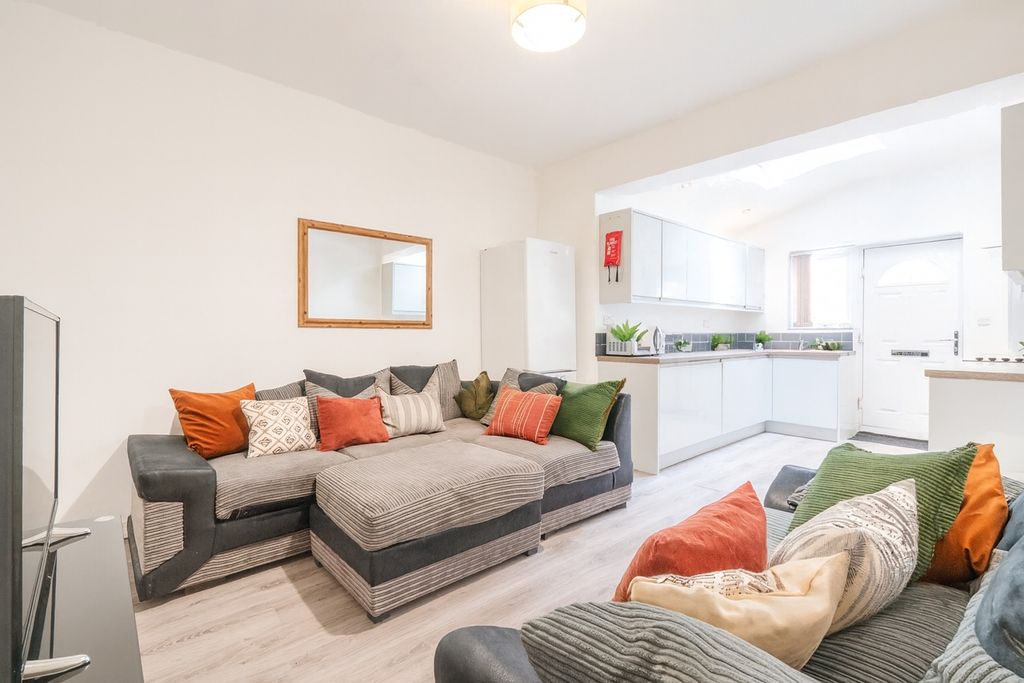 Property photo 1 of 8 Bright And Welcoming Living Room Featuring Comfort...