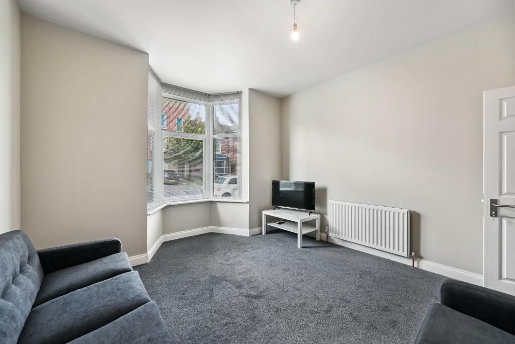 Property photo 2 of 15 A Bright And Inviting Living Room Featuring A Larg...