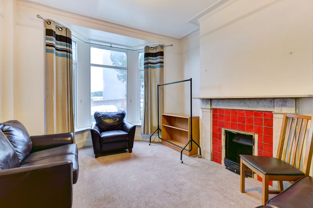 Property photo 2 of 18 A Bright And Inviting Living Room Featuring Comfor...