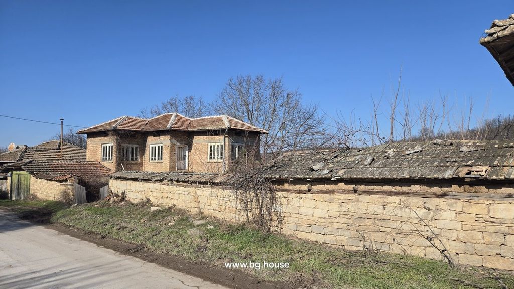 Property photo 3 of 57 Stone Wall With Tiled Roof Along A Village Street Near A Two-Storey Brick House