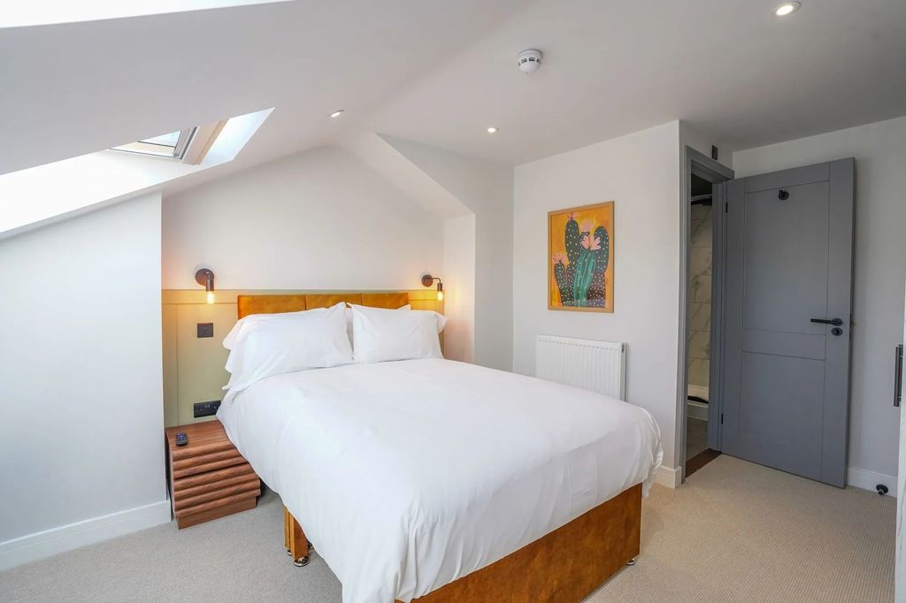 Property photo 3 of 14 Bright And Stylish Bedroom Featuring A Comfortable...