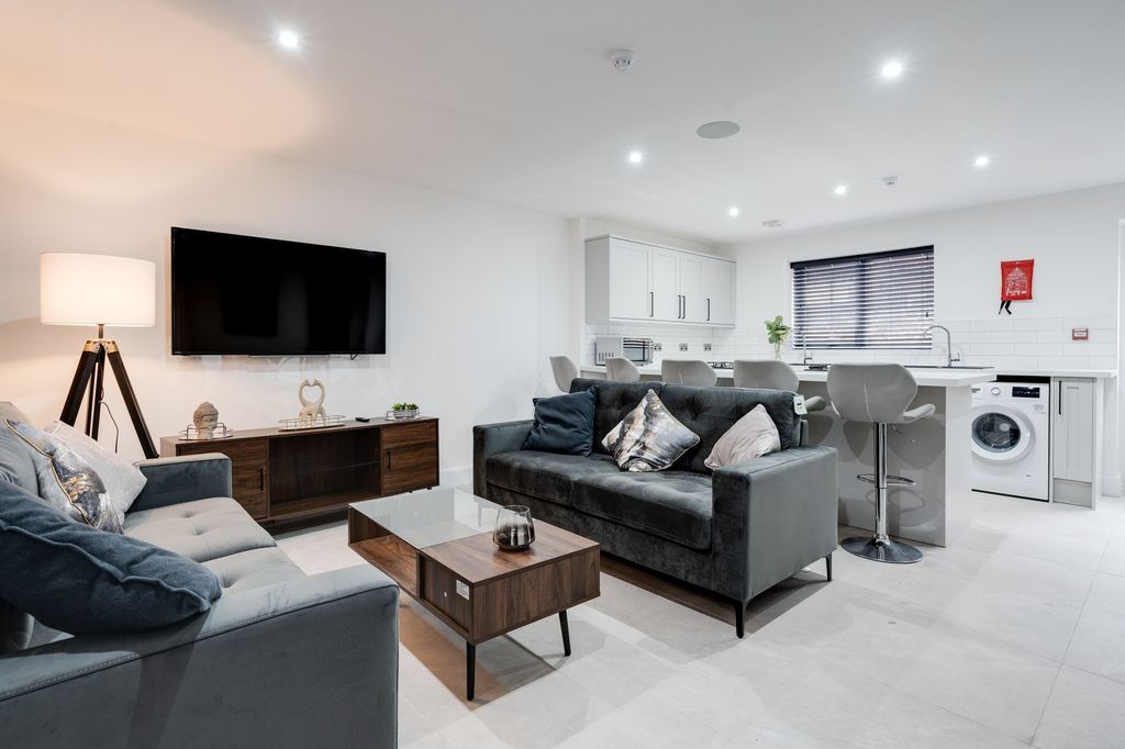 Property photo 1 of 8 Bright And Modern Living Room Featuring Two Comfor...