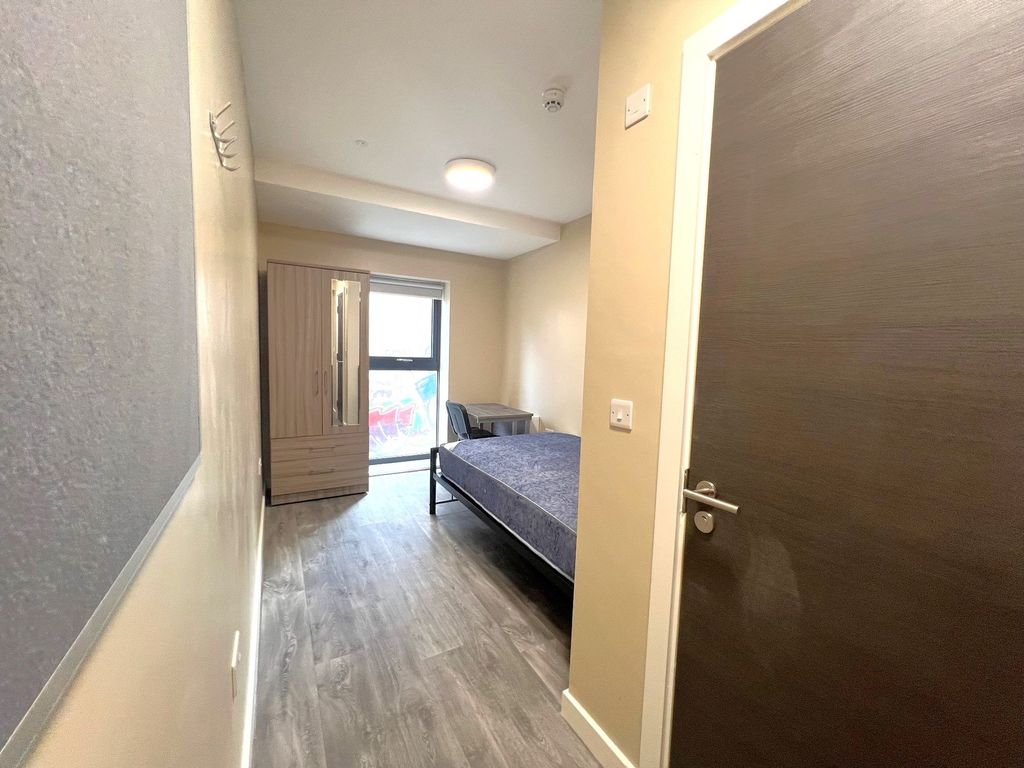 Property photo 2 of 9 A Clean, Well-Lit Bedroom Featuring A Single Bed, ...