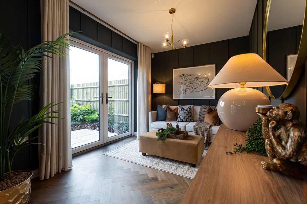 Property photo 3 of 10 A Modern Living Room With A Large Plant And French Doors Opening To A Garden In The Foreground