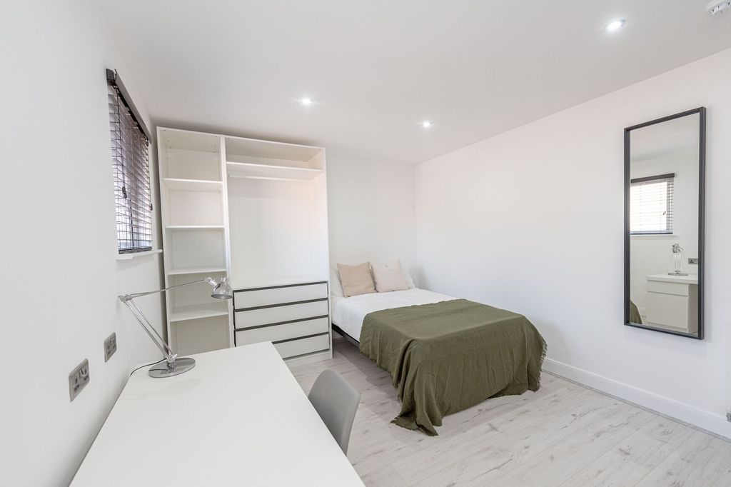 Property photo 3 of 12 A Clean, Well-Lit Bedroom Featuring A Comfortable ...