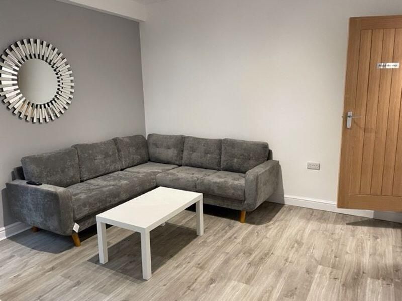 Property photo 3 of 11 A Bright And Spacious Living Room Featuring A Mode...