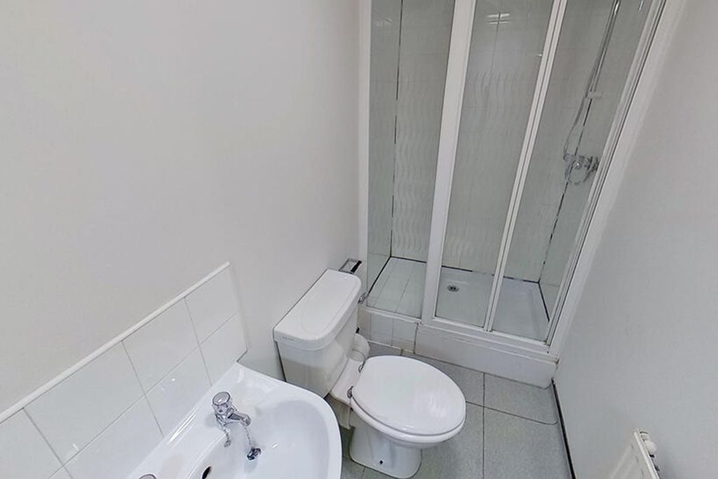 Property photo 1 of 8 A Modern Bathroom Featuring A Sleek Shower Enclosu...