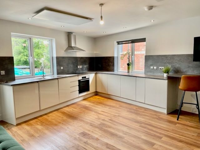 Property photo 1 of 11 Bright Modern Kitchen With L-Shaped White Cabinetr...