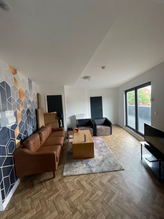 Property photo 3 of 11 A Spacious And Inviting Living Room Featuring Mode...