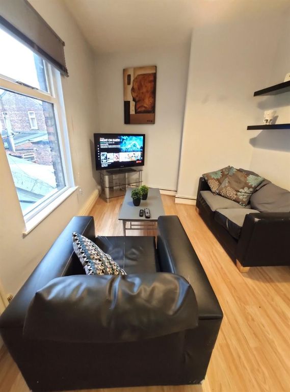 Property photo 1 of 8 A Cozy Living Room Featuring Black Leather Sofas A...