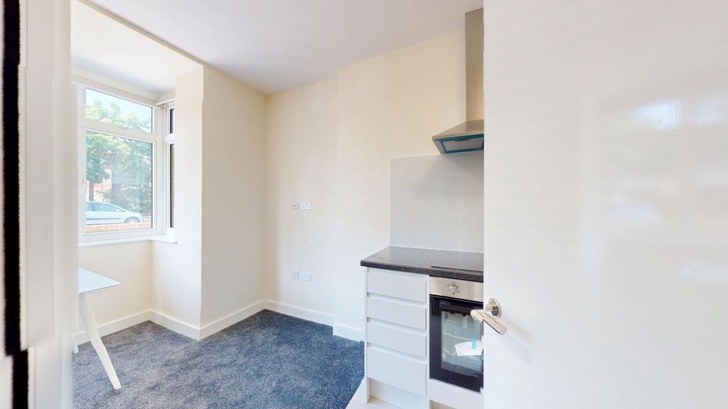 Property photo 3 of 14 Bright And Clean Kitchen Featuring Modern White Ca...
