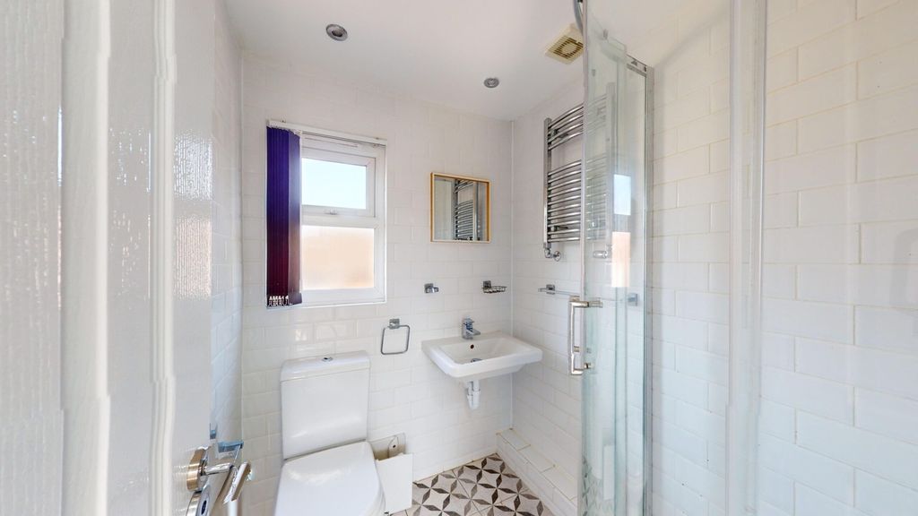 Property photo 3 of 13 A Bright And Modern Bathroom Featuring A Stylish S...