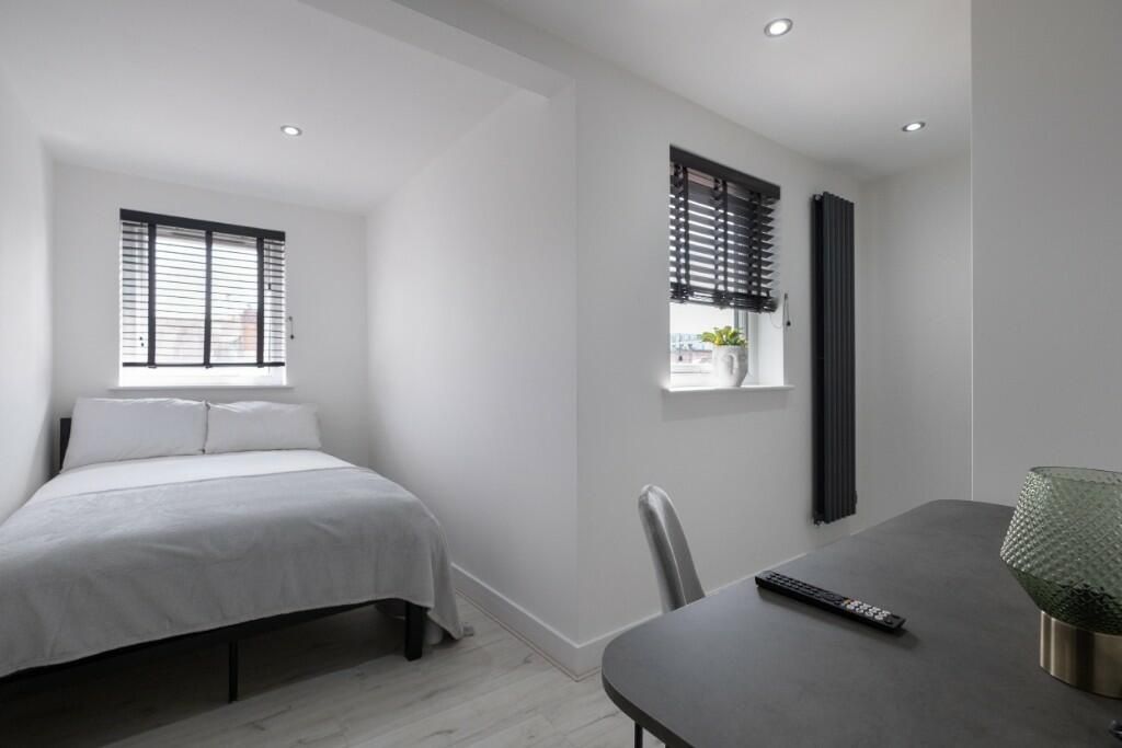 Property photo 2 of 11 A Well-Lit, Modern Master Bedroom Featuring A Comf...