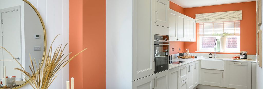 Property photo 2 of 5 View Into Kitchen With White Panels And Countertops, Orange Walls.