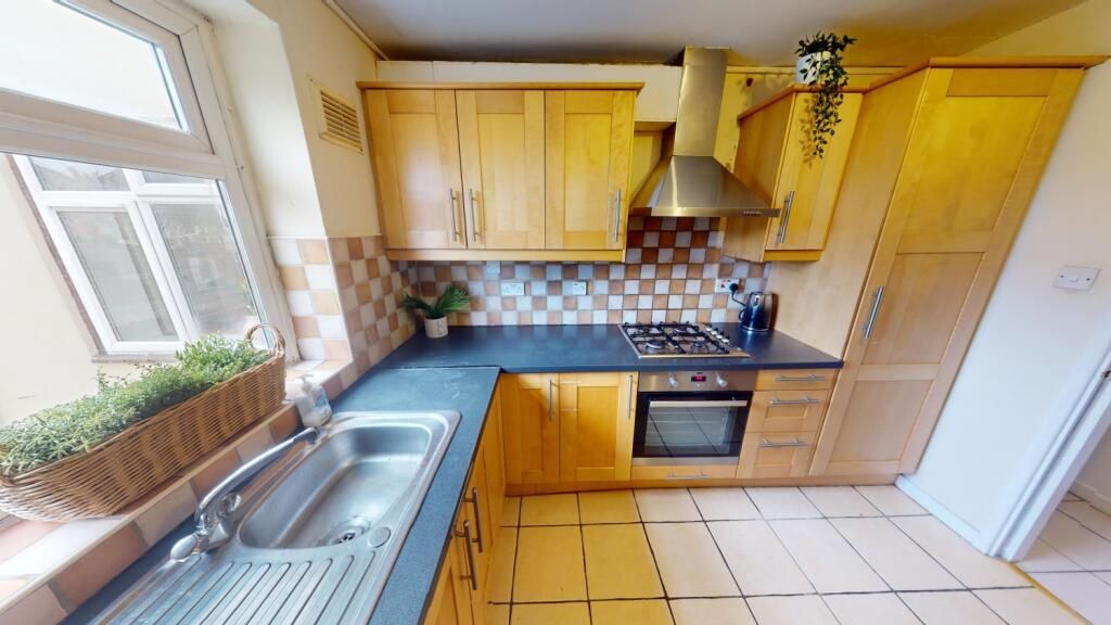 Property photo 3 of 10 Bright And Tidy Kitchen Featuring Wooden Cabinetry...