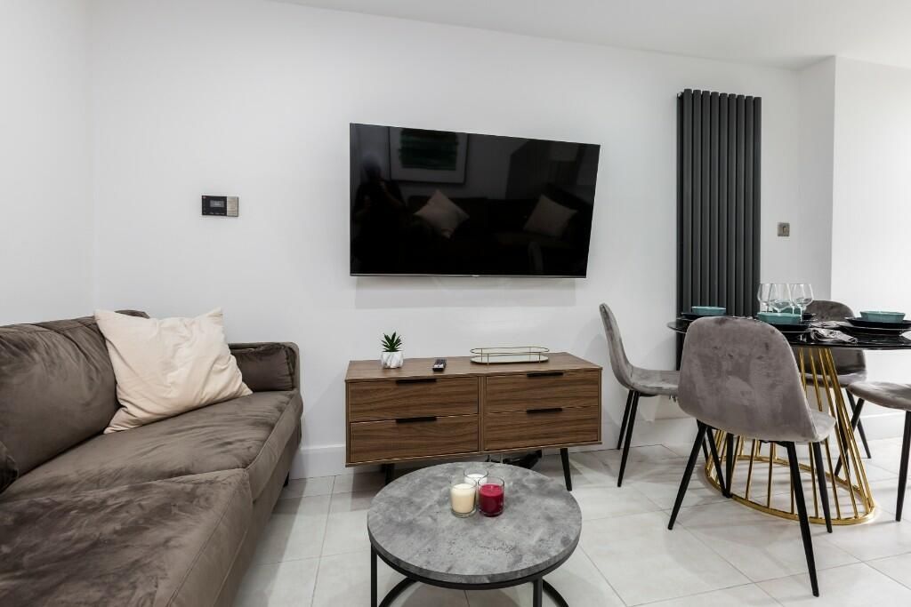 Property photo 2 of 15 A Modern And Inviting Living Room Featuring A Larg...