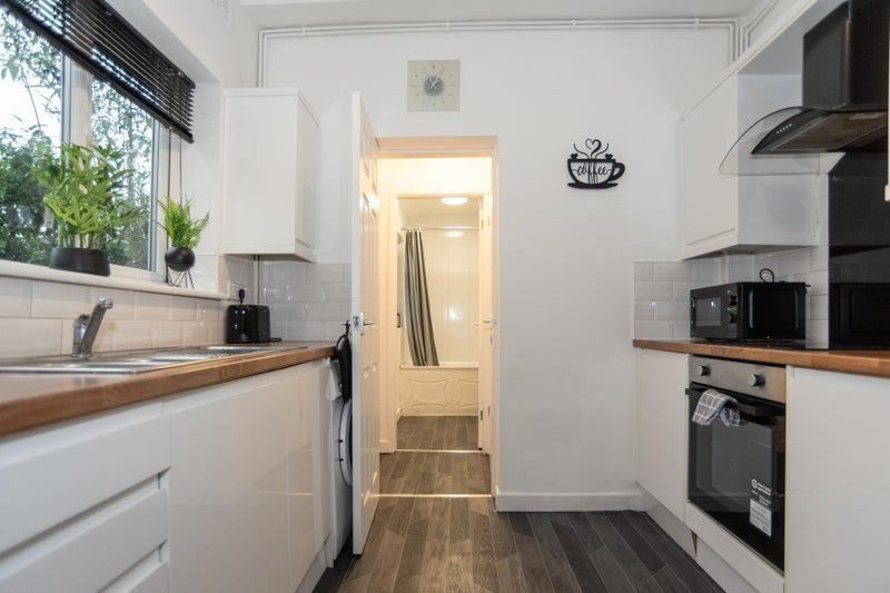 Property photo 3 of 11 Bright Modern Galley Kitchen With Wood-Effect Work...