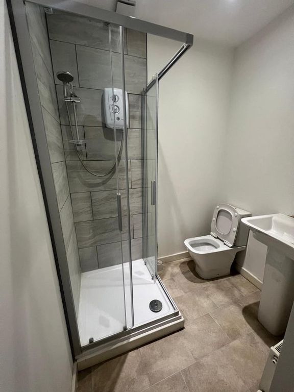Property photo 3 of 3 A Modern Bathroom Featuring A Walk-In Shower With ...