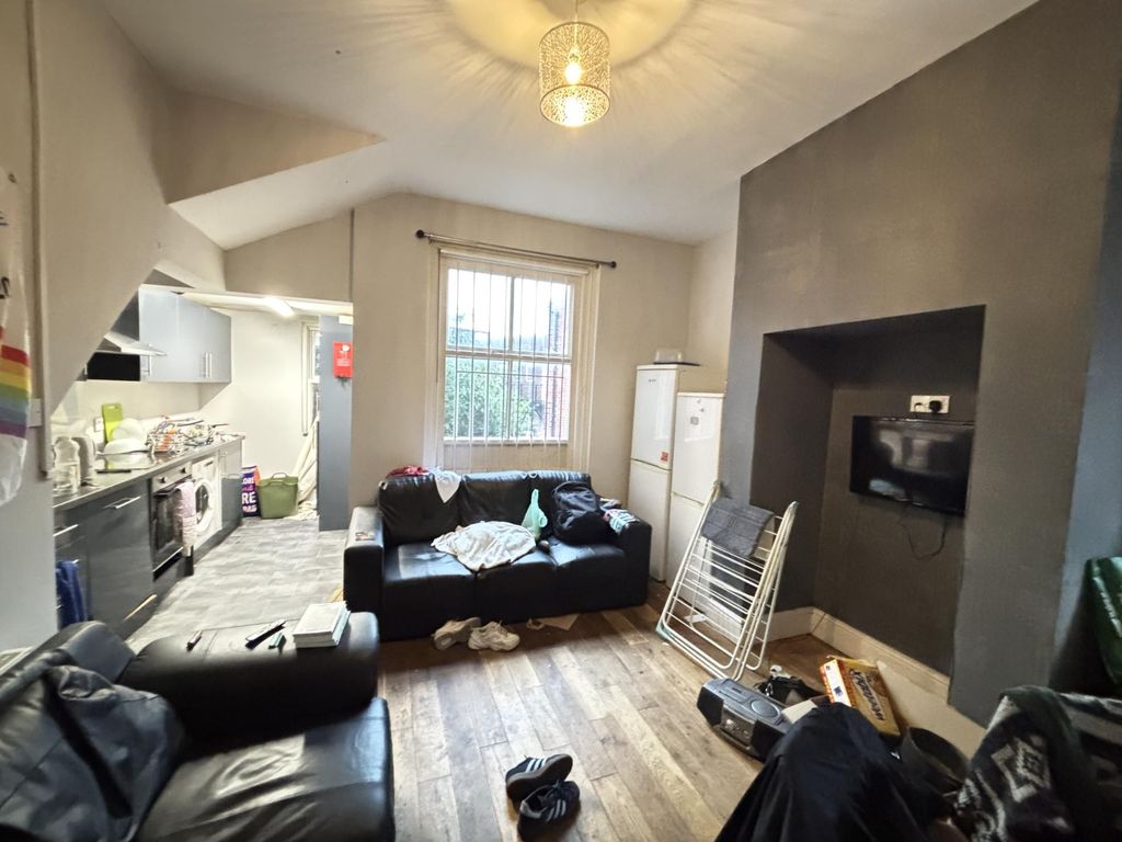 Property photo 2 of 15 A Cozy And Well-Lit Living Room With A Large Windo...