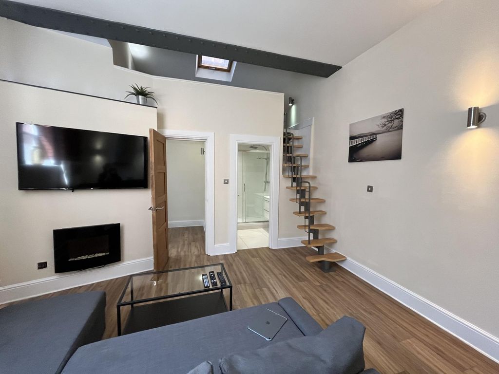 Property photo 2 of 16 Modern And Stylish Living Room Featuring A Wall-Mo...