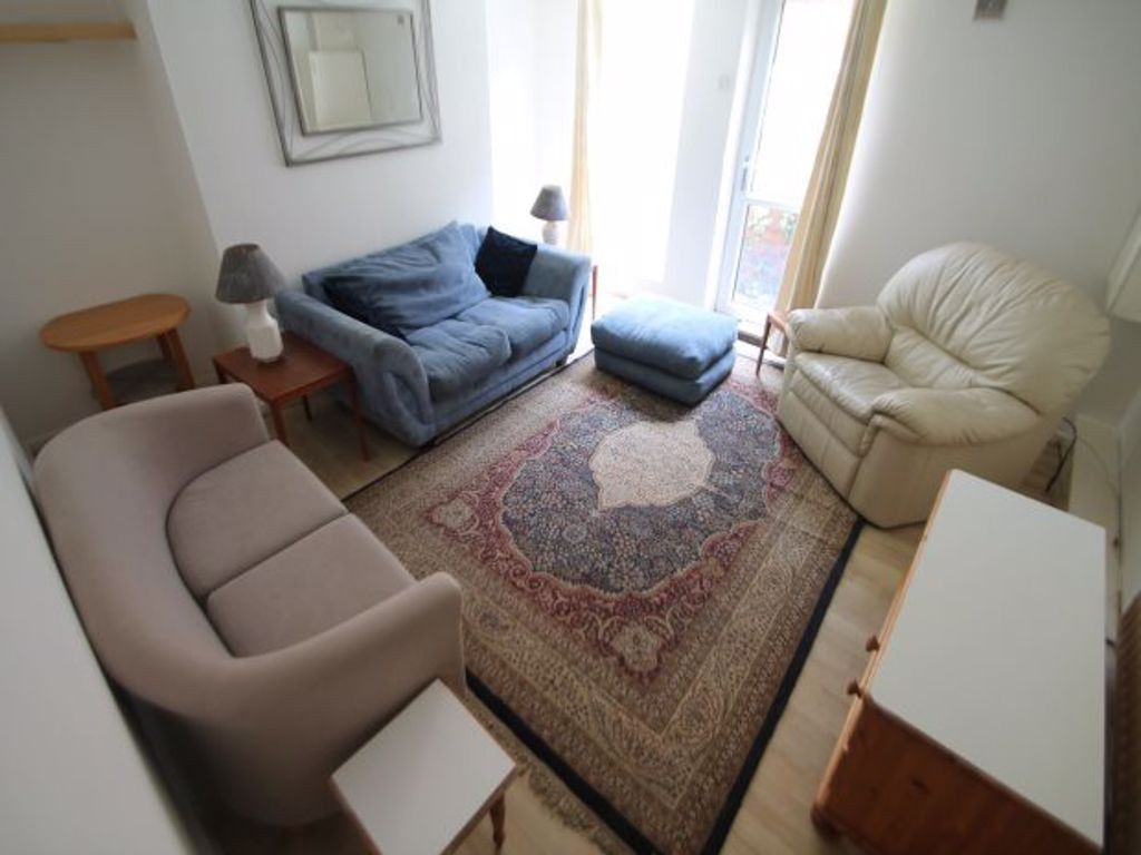 Property photo 1 of 22 A Bright And Inviting Living Room Featuring A Vari...