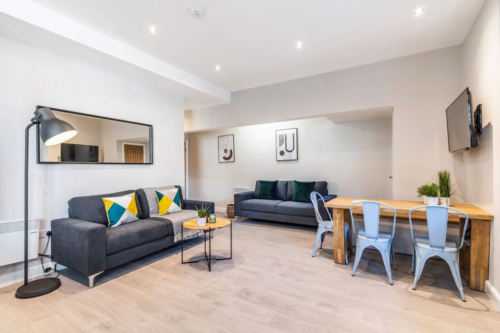 Property photo 1 of 12 A Modern, Spacious Living Room Featuring Comfortab...